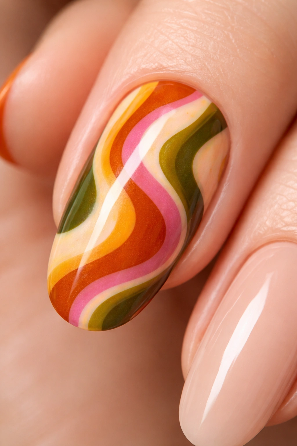 Close-up of retro 70s swirl nail art with warm color blends