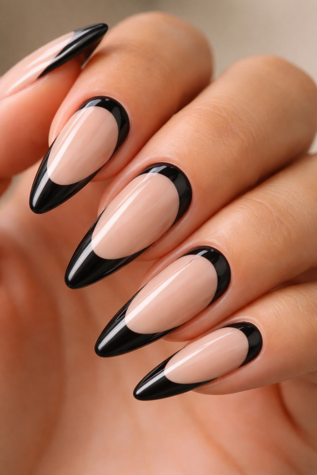 Long almond nails with reverse black French tips near the cuticle