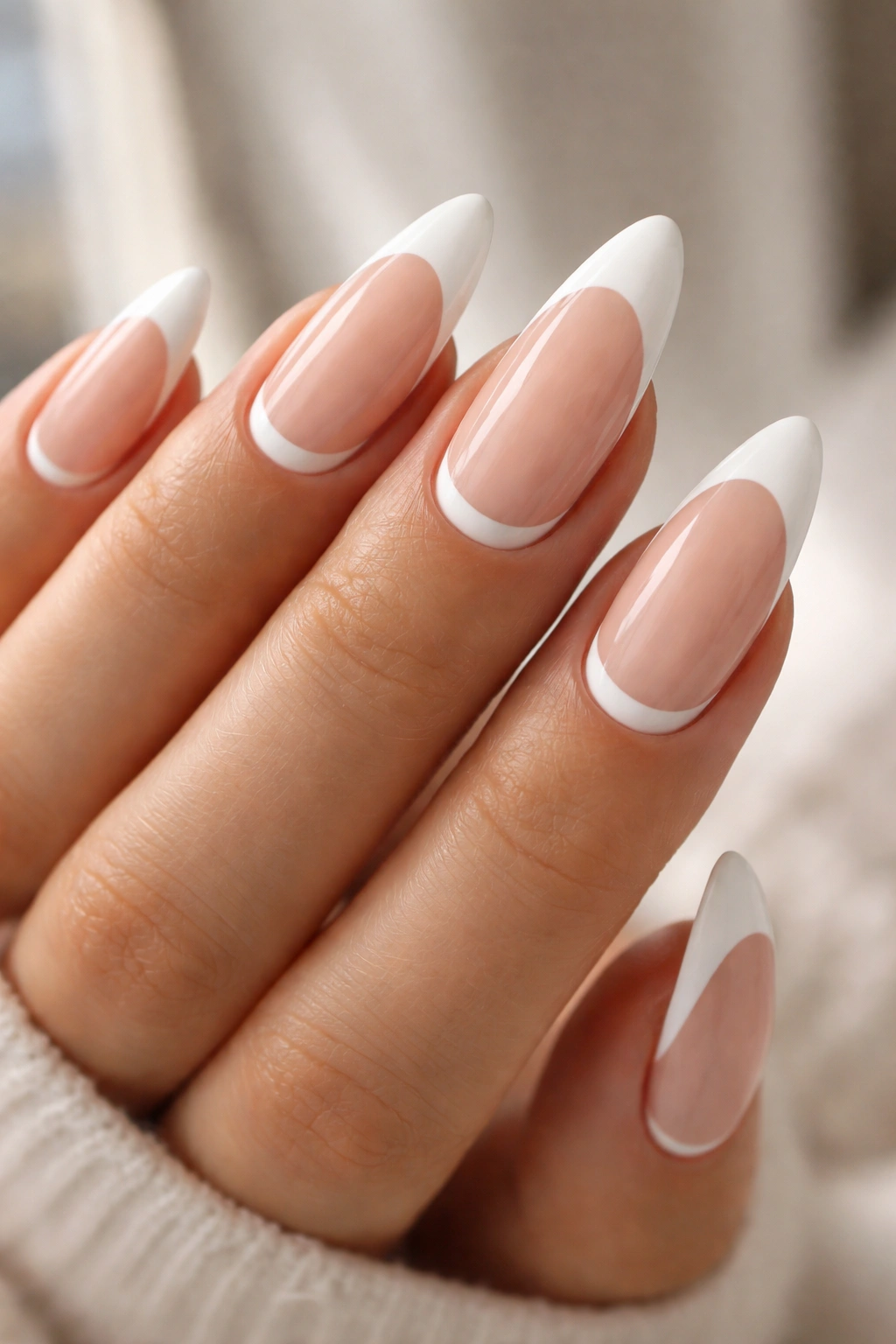 Long almond nails with a reverse white French crescent near the cuticle