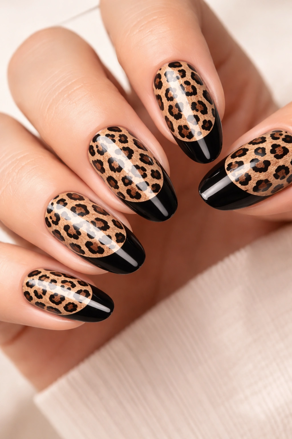 Leopard print nails with reversed French manicure showing leopard base and tip color