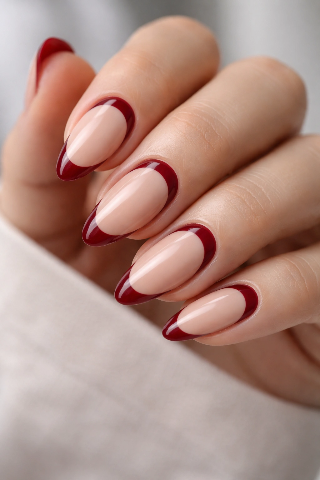 Almond nails with reverse red French near cuticle