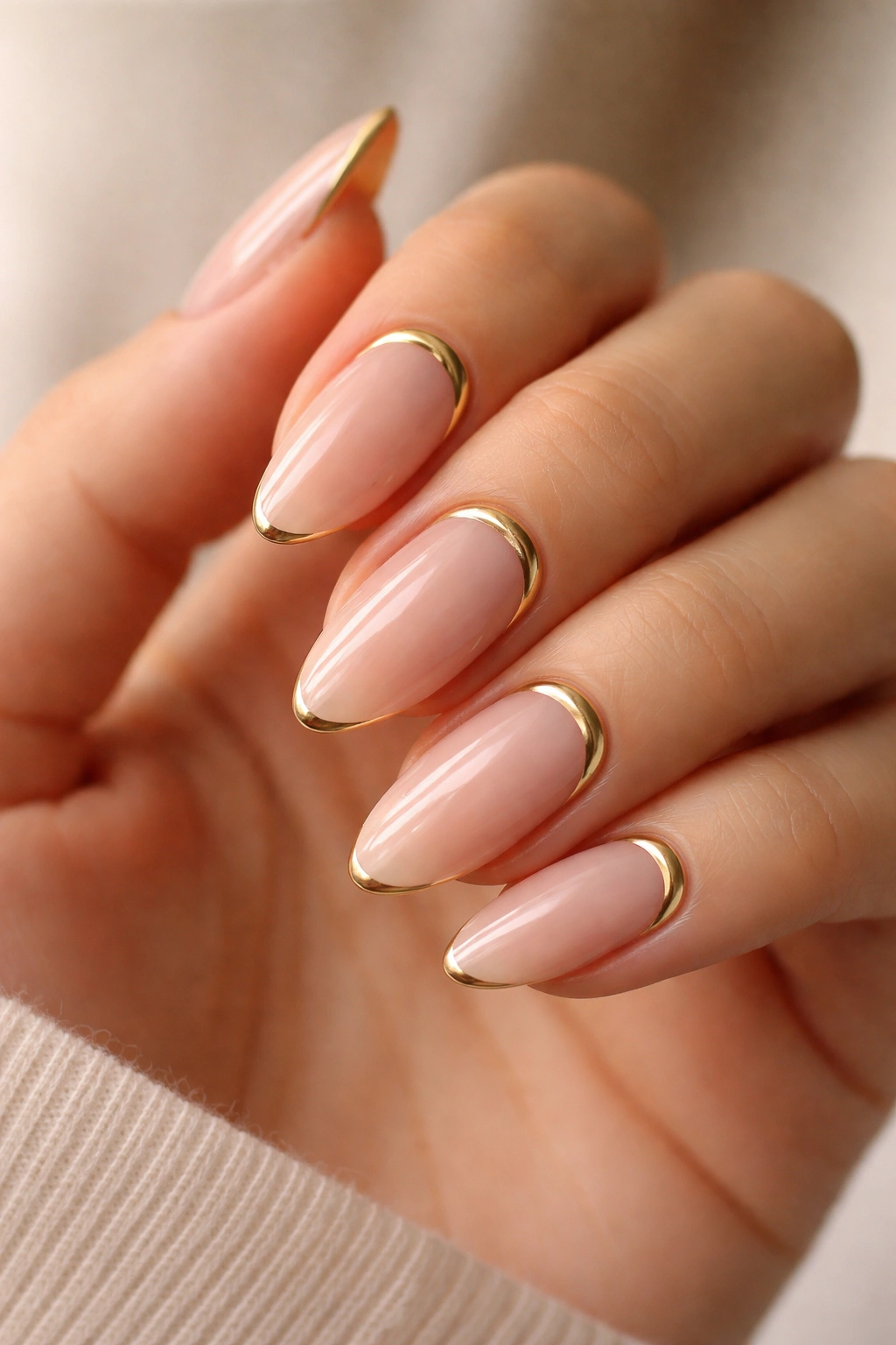 Almond nails with reverse gold French line at cuticle on a sheer base