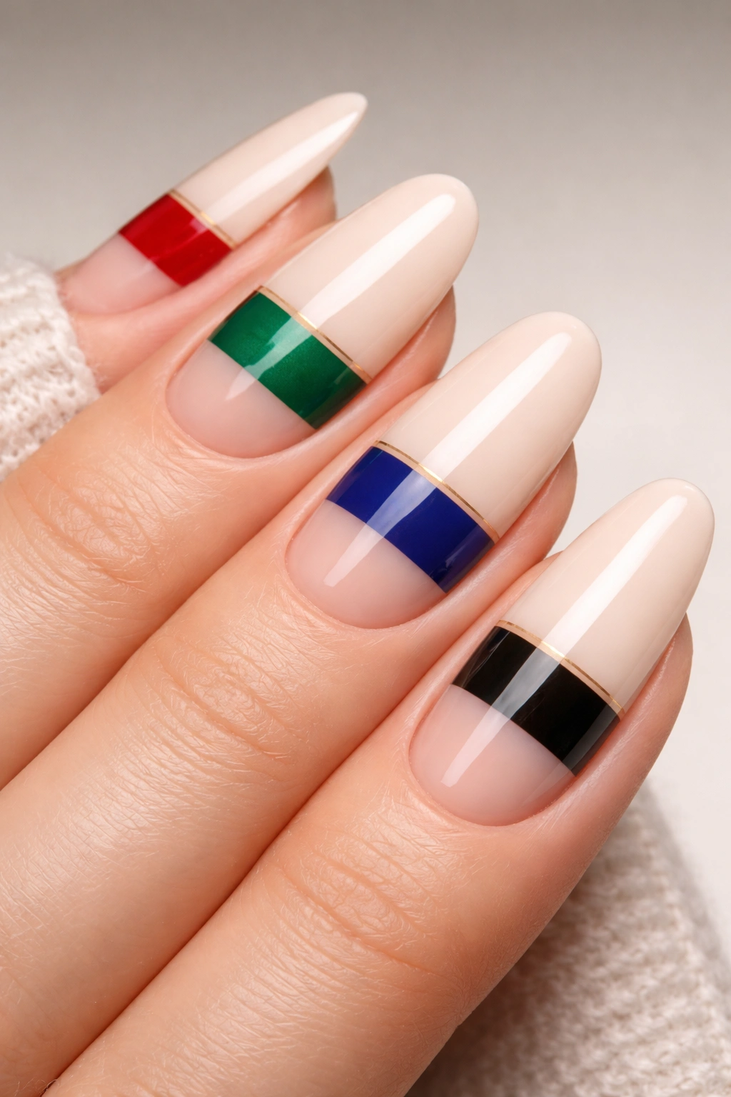 Close-up of a long oval nail with a white/nude base and a bold color-block band across the middle