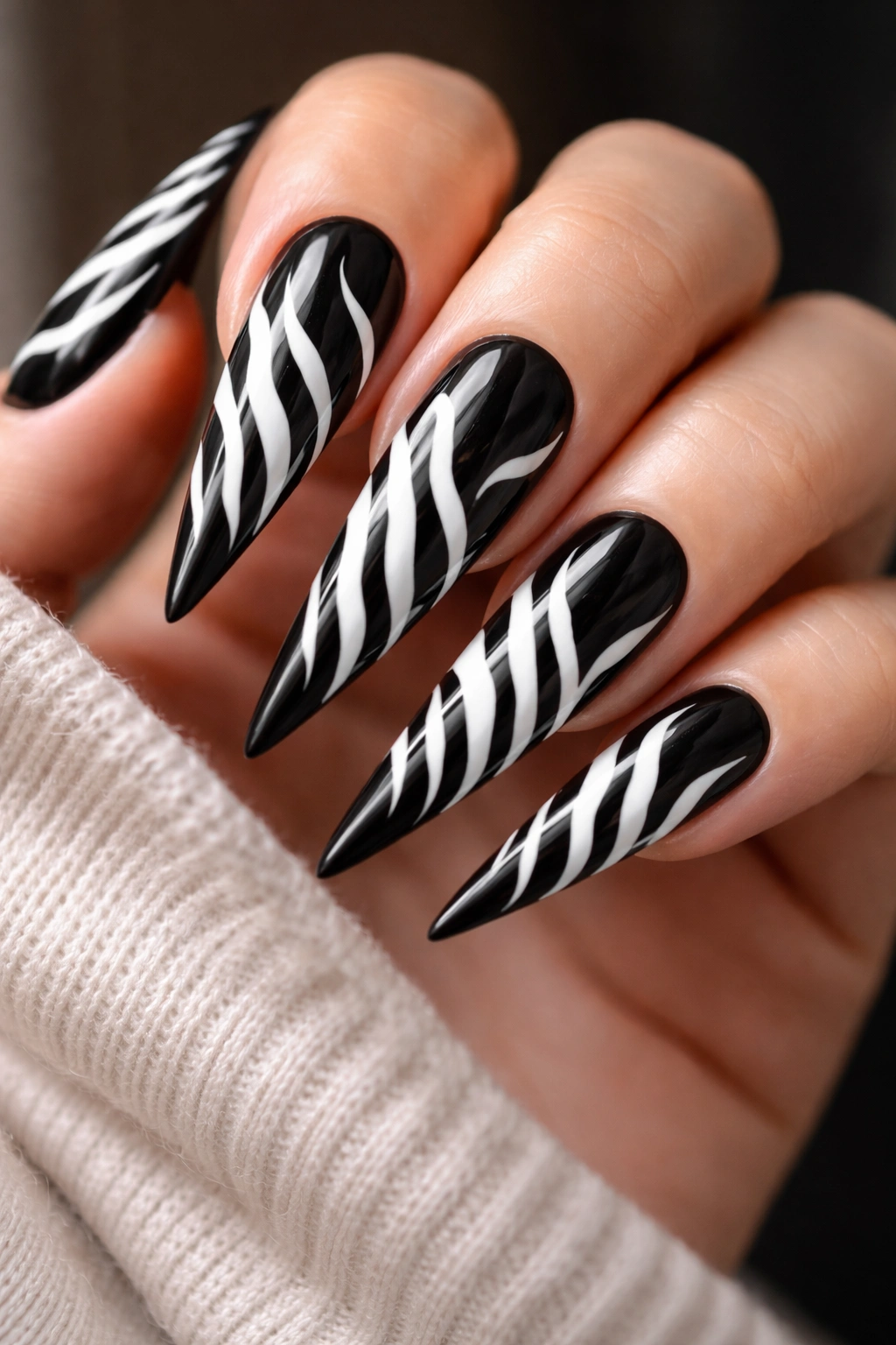 Stiletto nails with white zebra stripes on black base