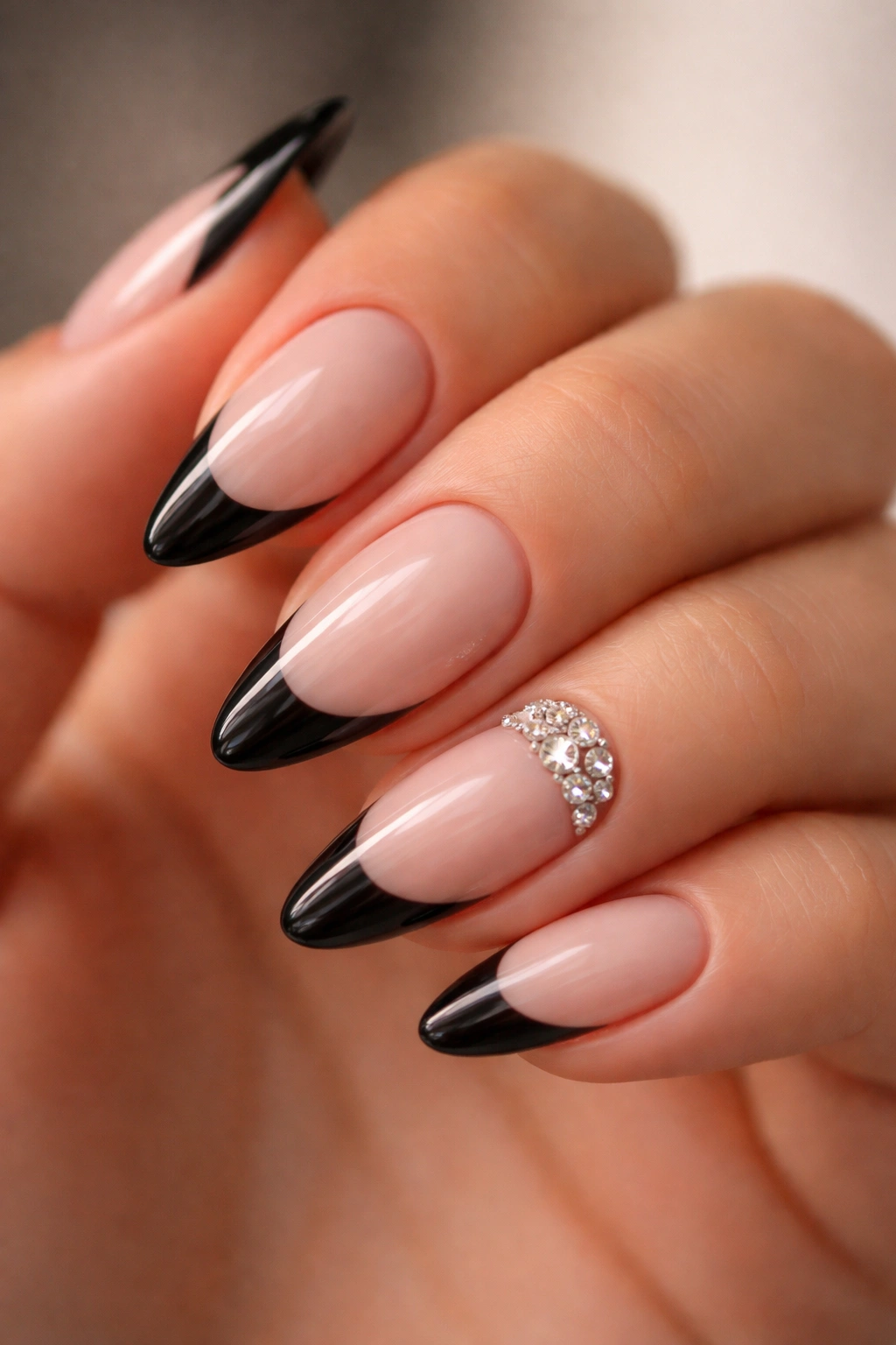 Black French manicure with rhinestone cluster on one nail