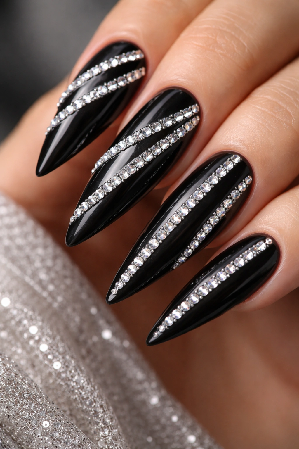 Black stiletto nail with rhinestone stripe pattern