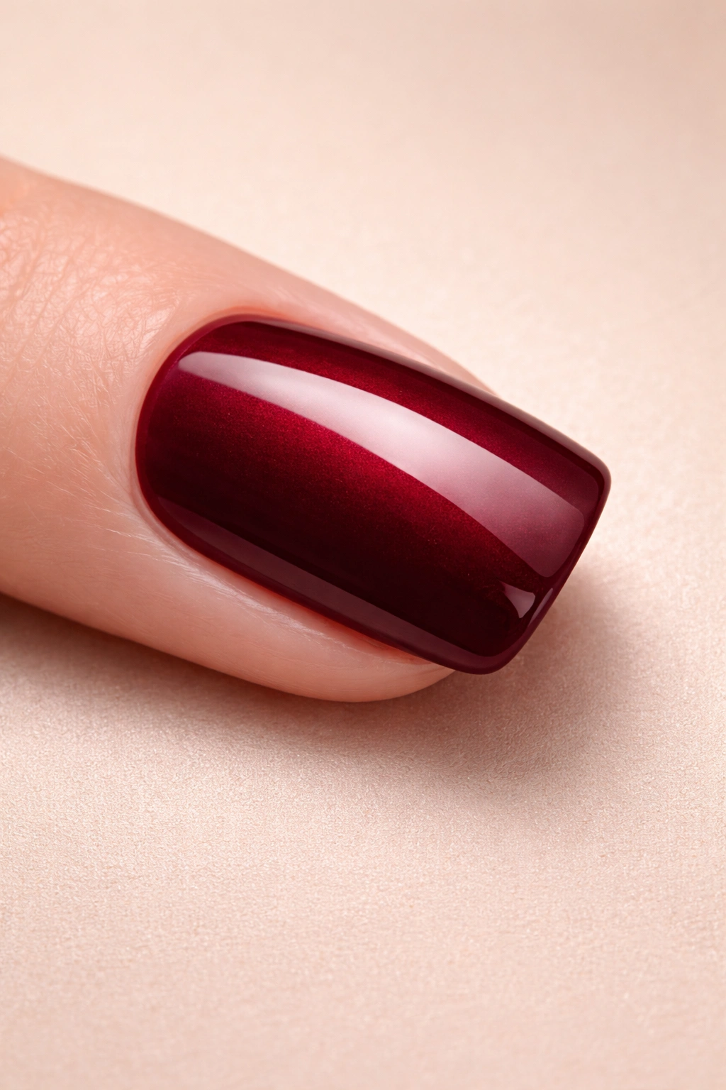Single rich-toned squoval nail on a clean surface representing final thoughts