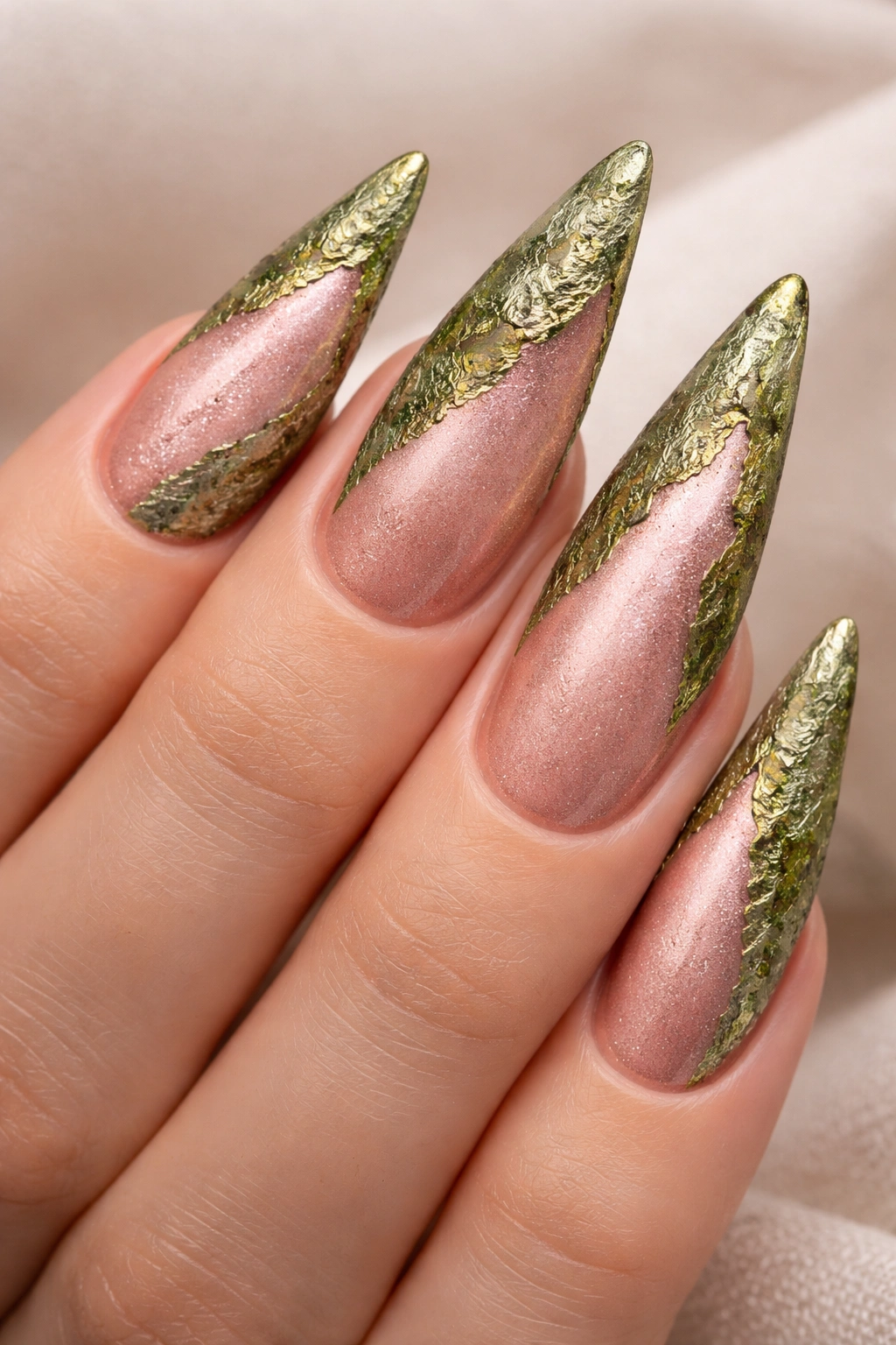 Close-up of rose gold pink nails with mossy green texture