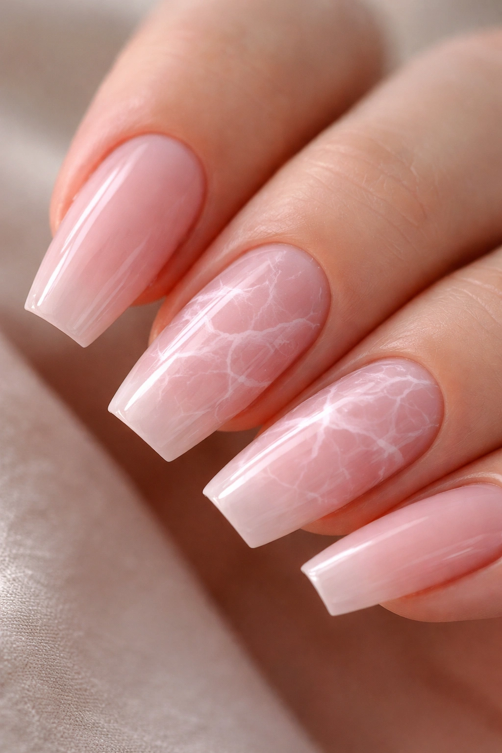 Rose quartz marble nails on sheer pink nails with soft veining