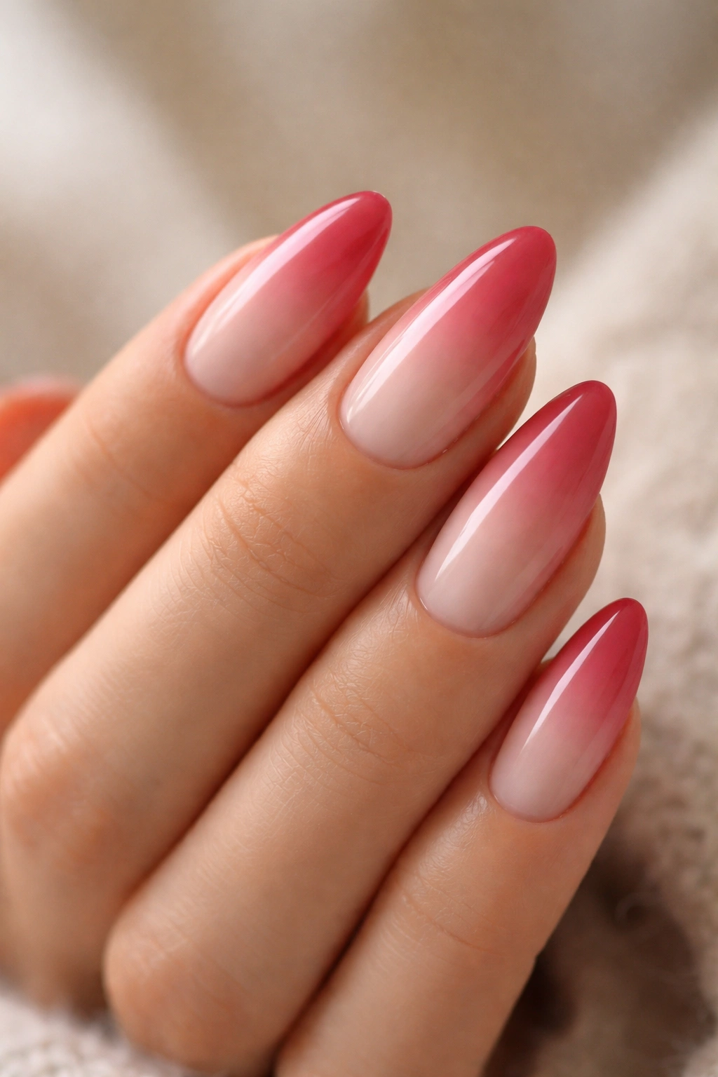 Almond nails with soft rose-red ombre over milky base