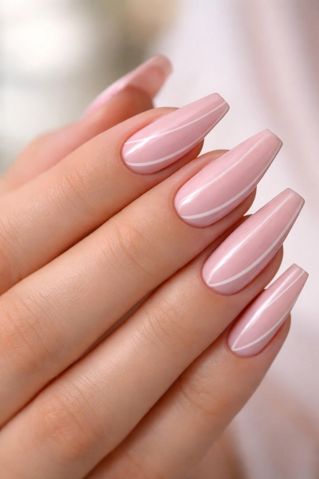 Close-up of rosewater pink ballerina nails with a subtle side-swept French sweep.