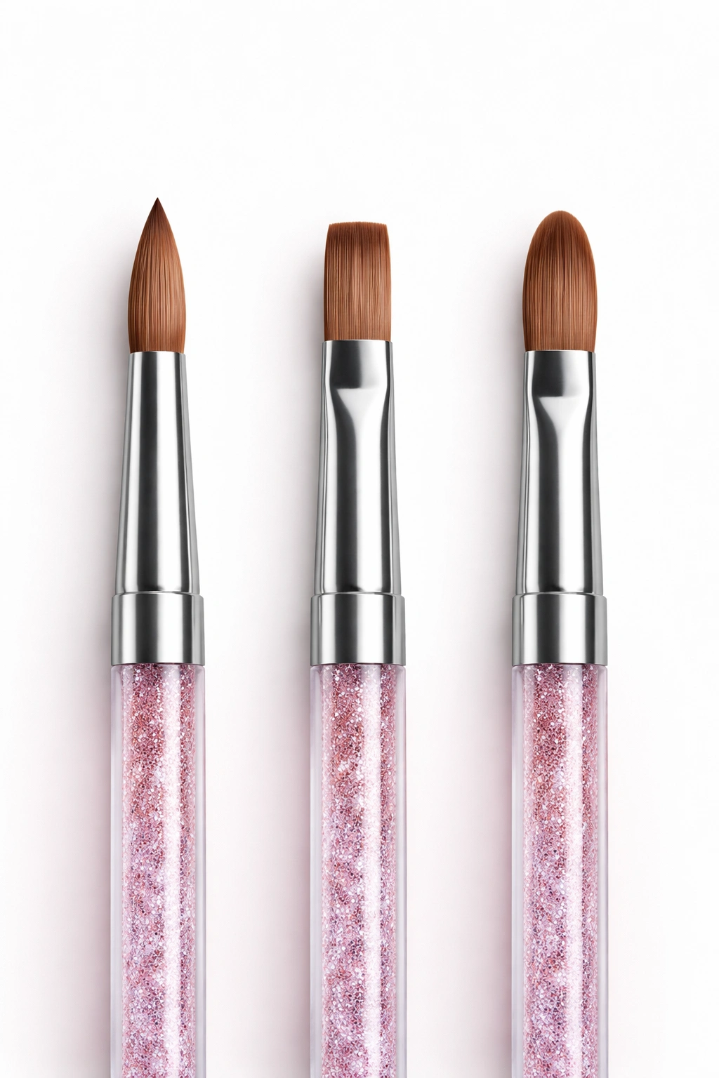 Three acrylic brushes showing round flat and oval shapes