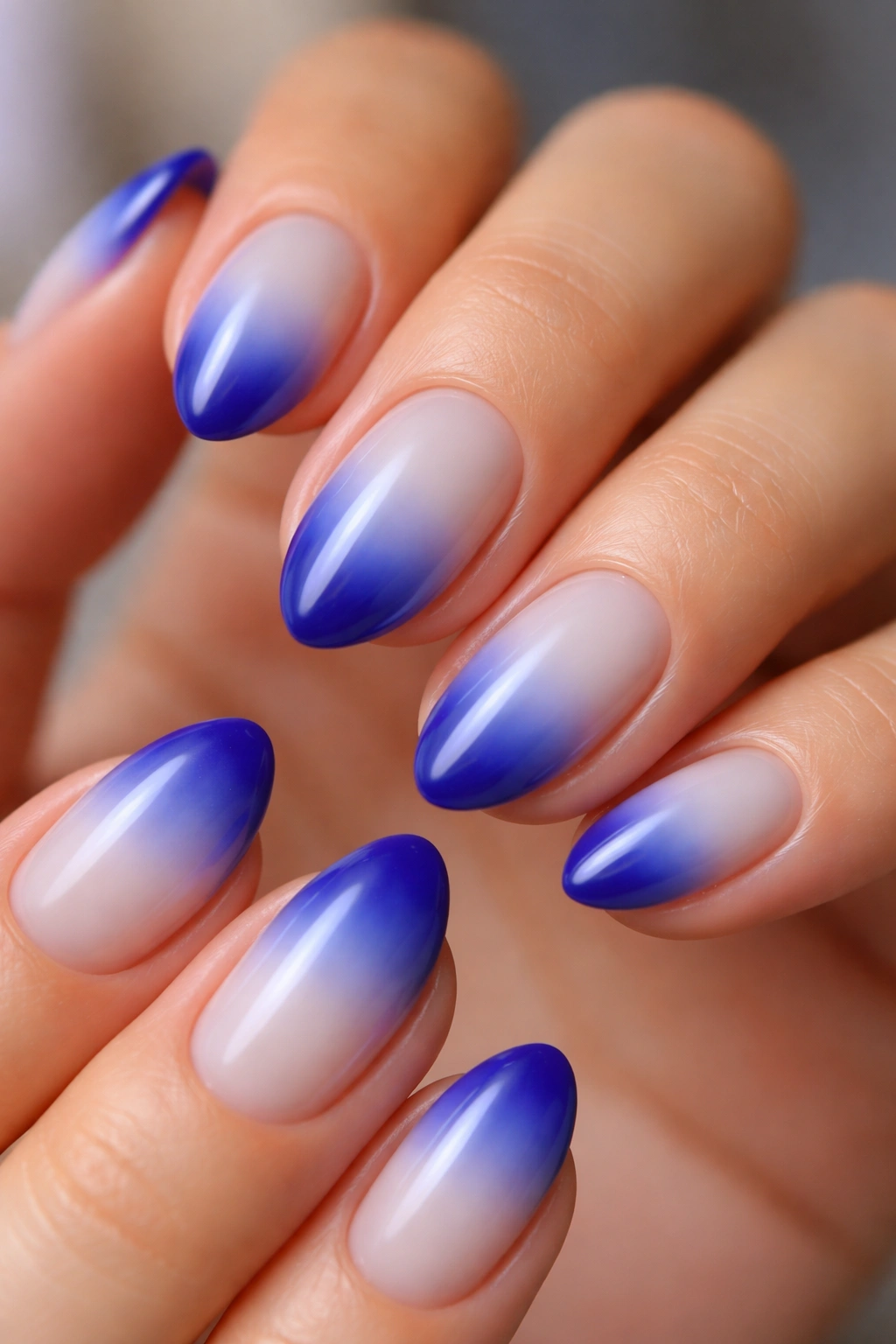 Royal blue aura fade on short almond nails with milky base