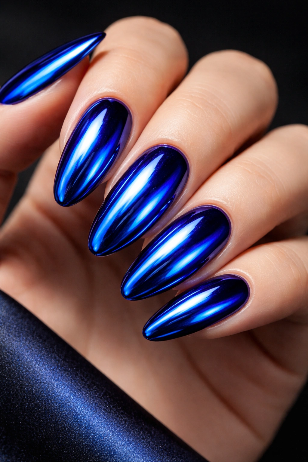 Royal blue chrome nails with mirror-like metallic finish