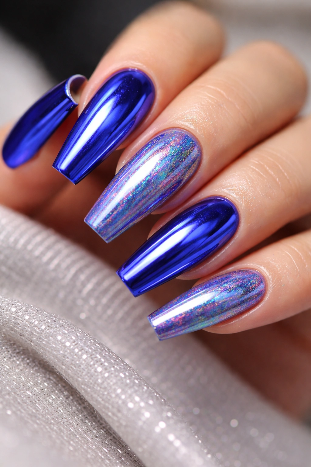 Close-up of coffin nails in royal blue with chrome and holographic powder