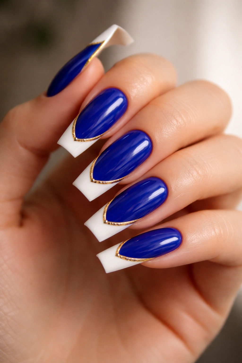 Royal blue coffin nails with white tips and gold edge