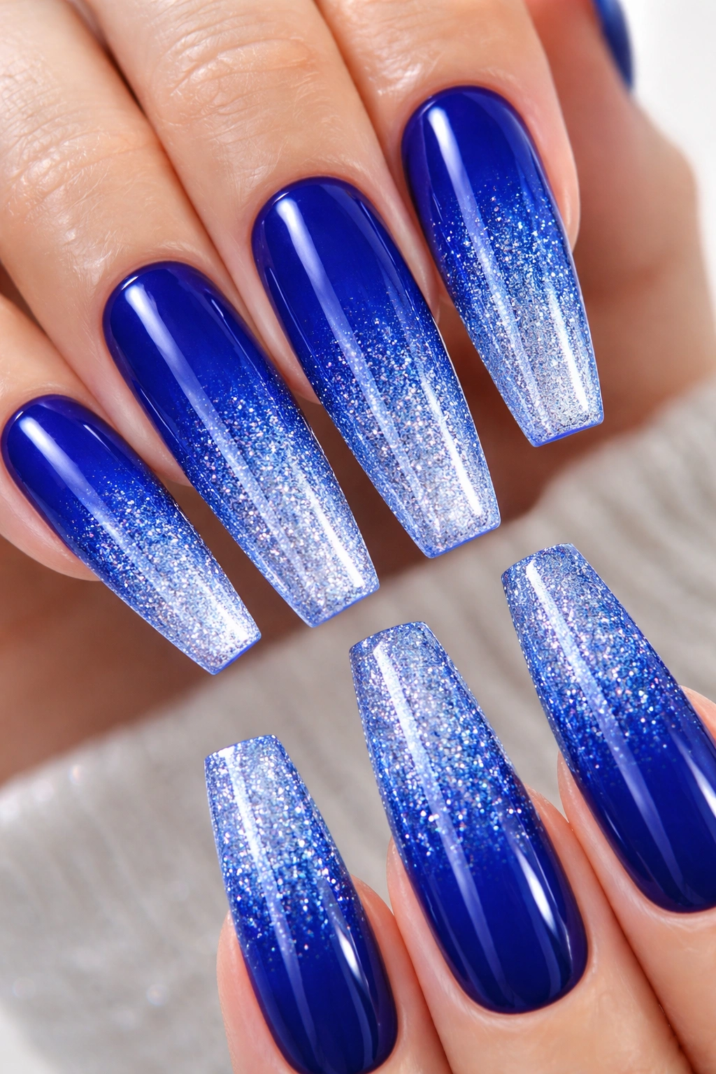 Royal blue coffin nails with glitter gradient ombre