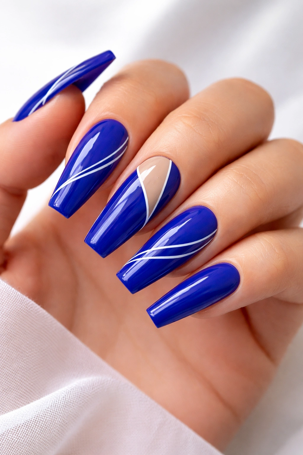 Royal blue coffin nails with minimalist line art and negative space