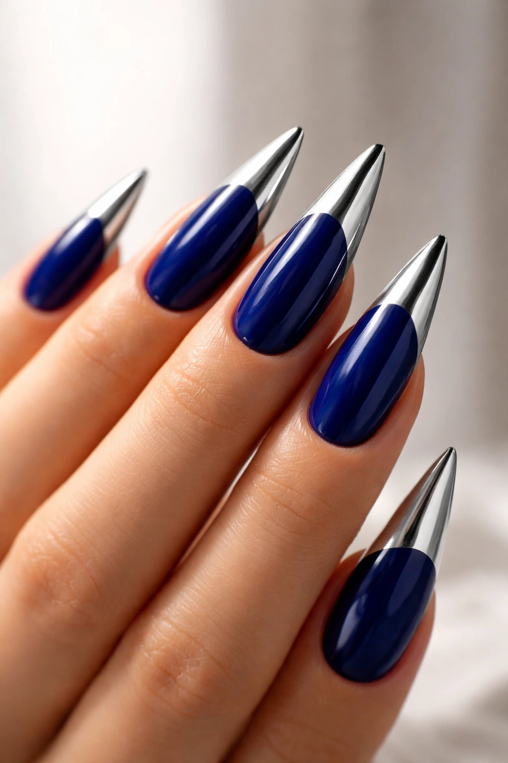 Royal blue stiletto nails with metallic chrome tips