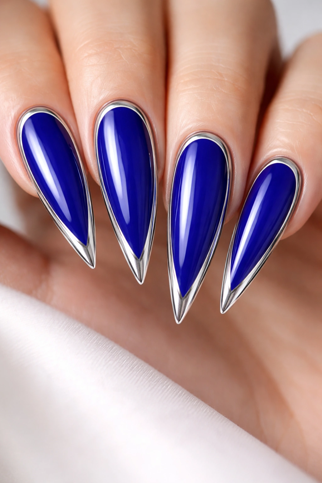 Royal blue nails with silver frame on stiletto tips