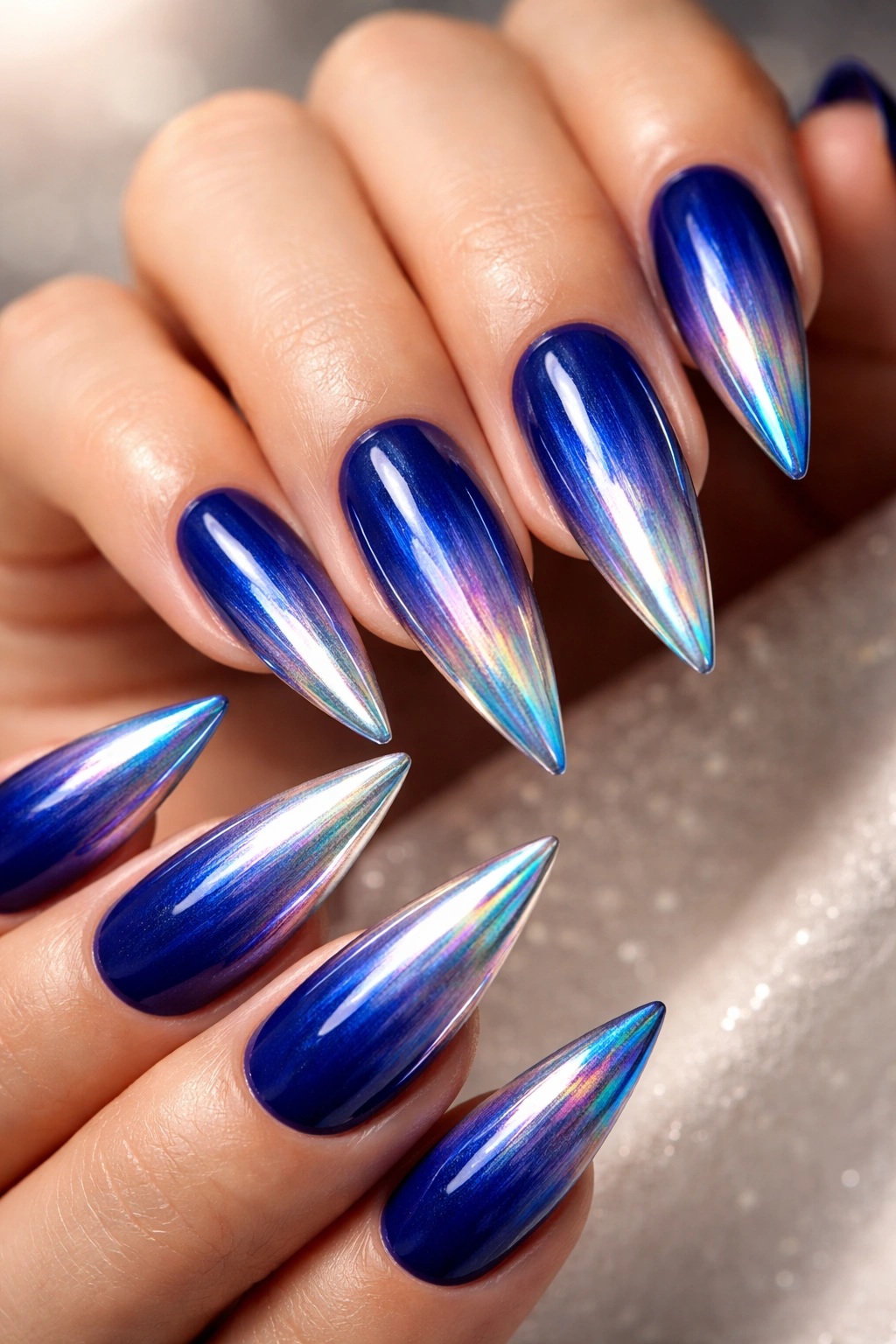 Royal blue ombre stiletto nails transitioning to chrome tips