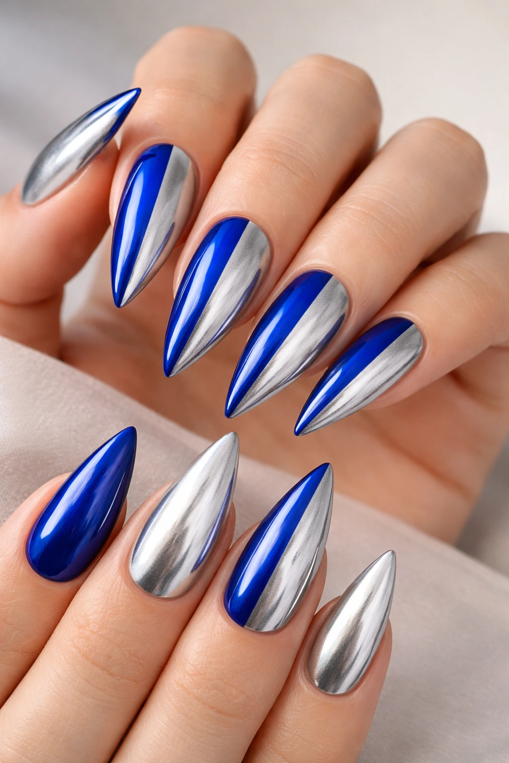 Two-tone royal blue and silver stiletto nails with a vertical split