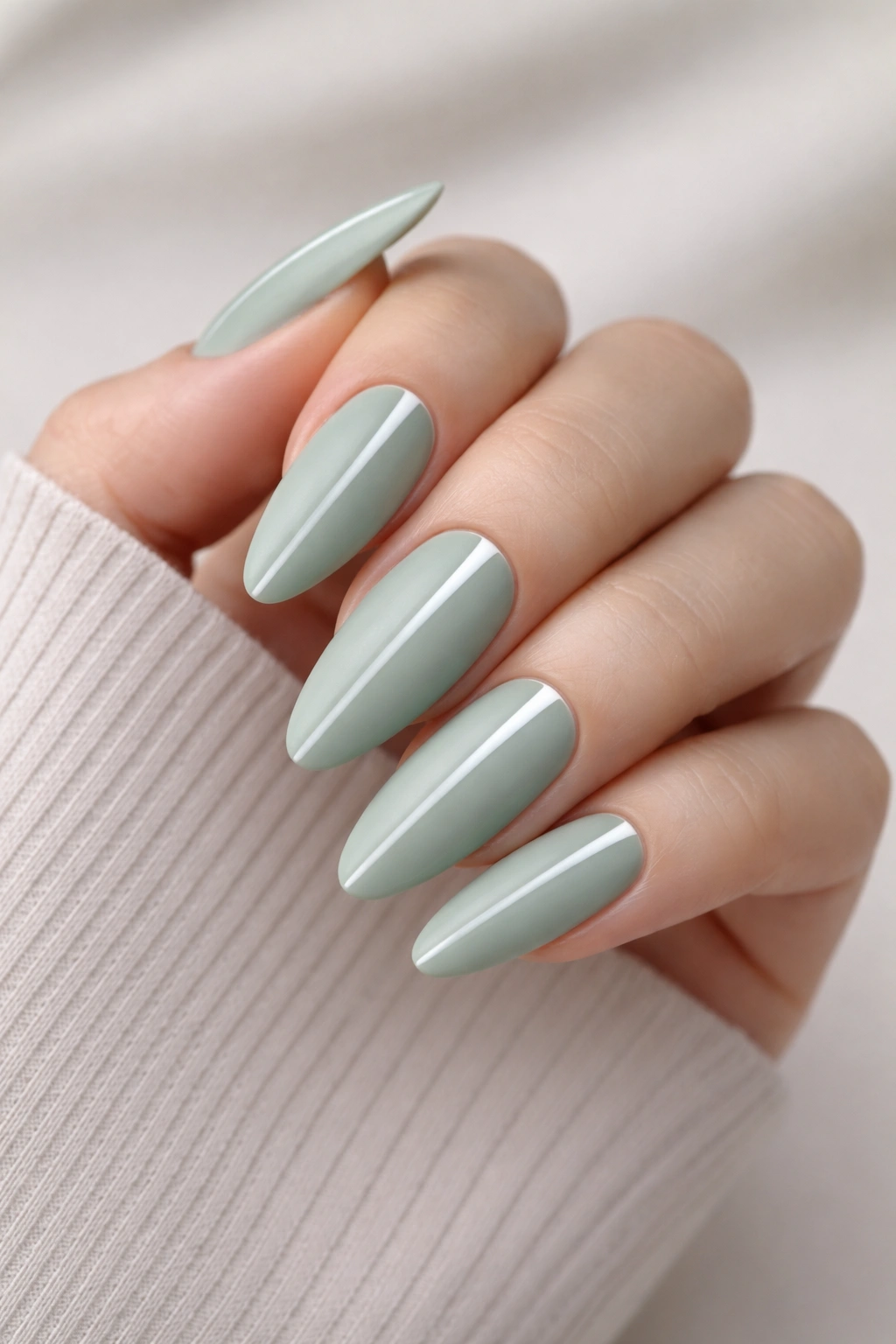 Almond nails in sage green matte with white accent lines