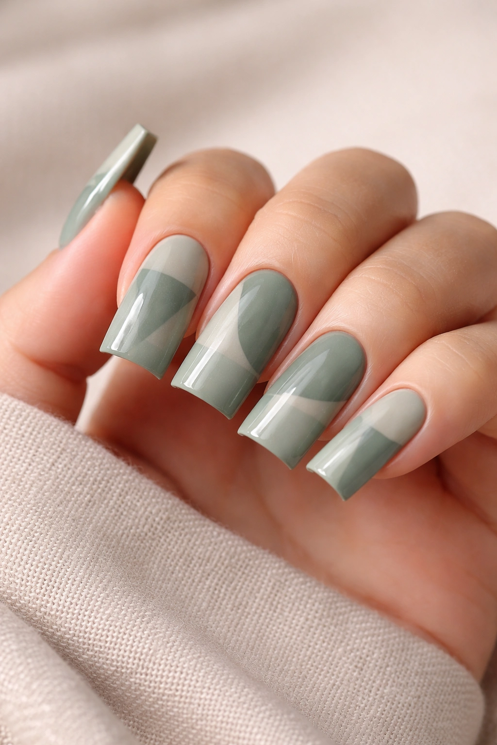 Muted sage green nails with glossy and matte texture blocking on medium duck nails