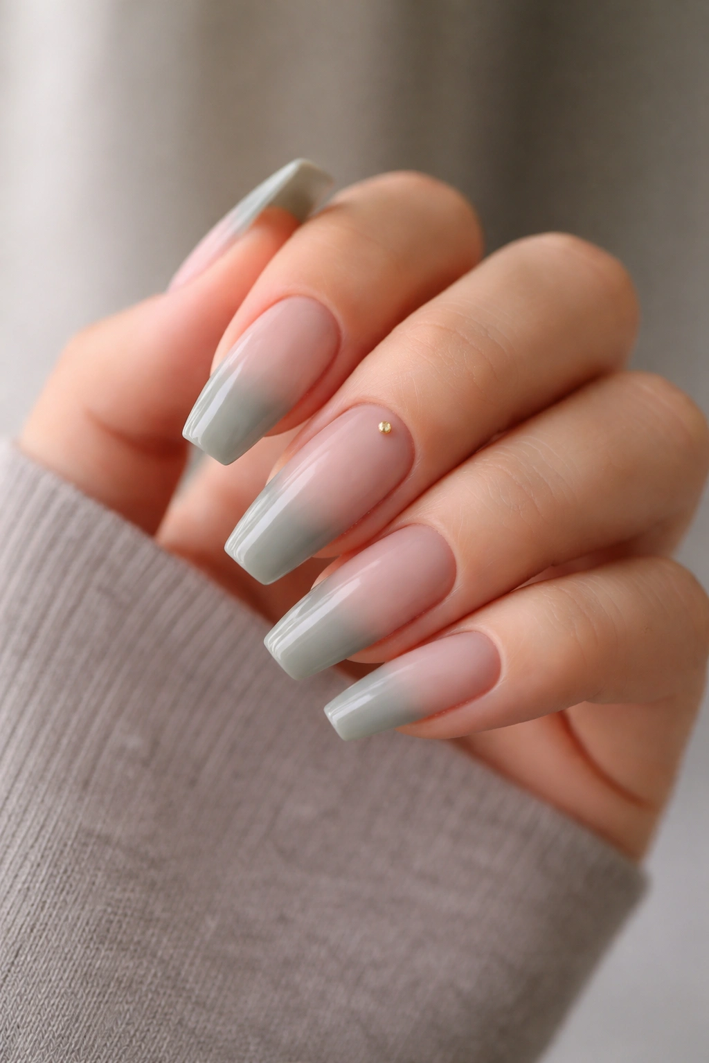Close-up of sage mist ombre nails on a ballerina shape
