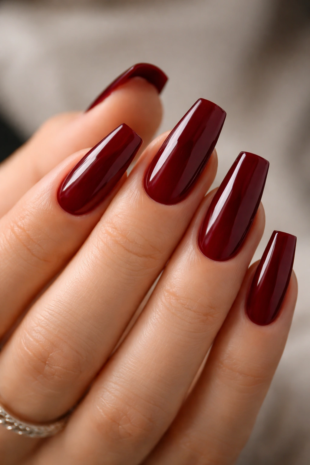 Close-up of deep red nails with crisp cuticle line