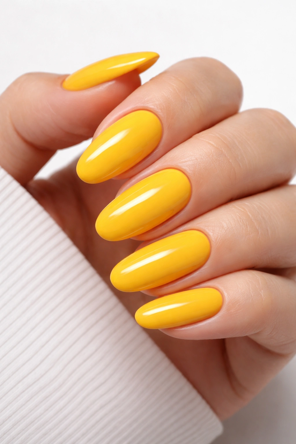 Close-up of bold school bus yellow nails on a hand for back-to-school look