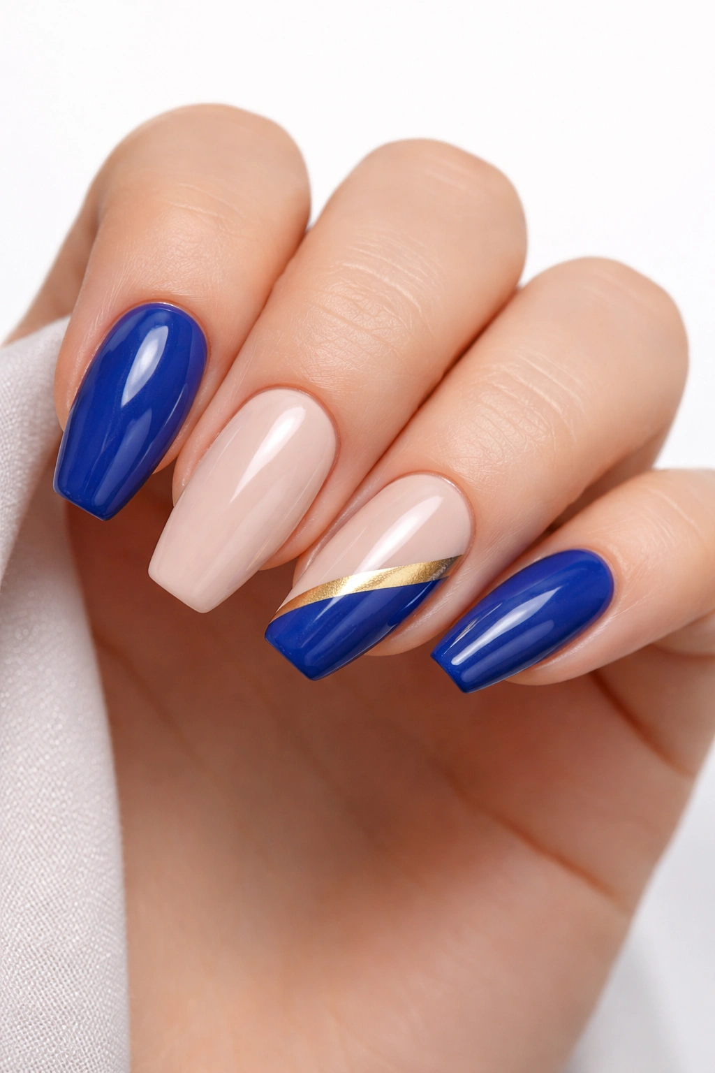 Nails in royal blue with gold accent stripe