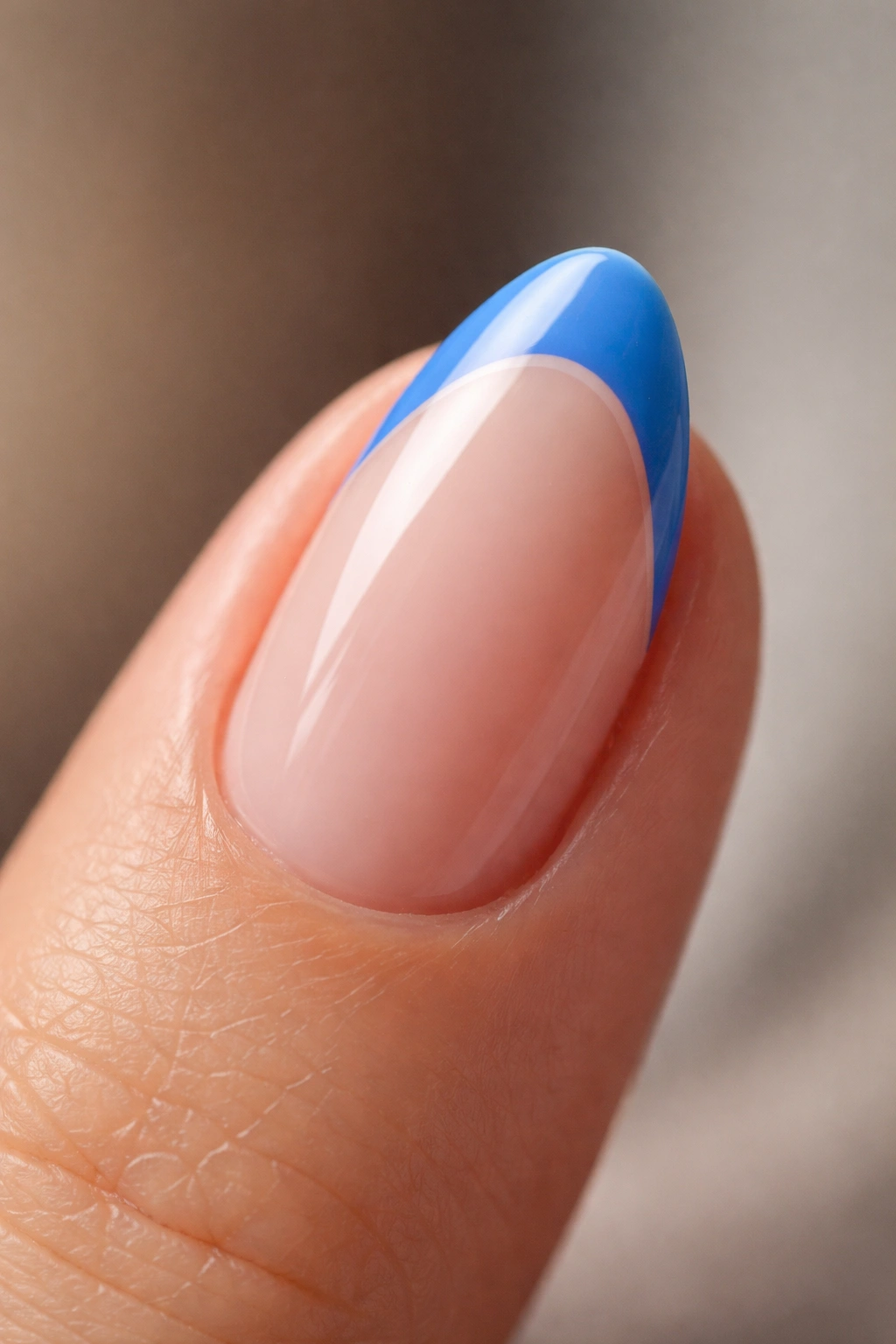 Close-up of a short almond nail with a crisp, sharp French tip boundary.