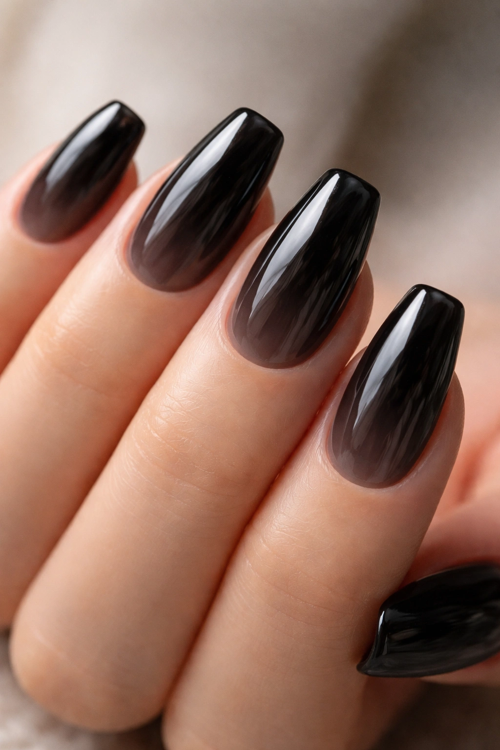 Close-up of sheer black jelly nails on short ballerina nails