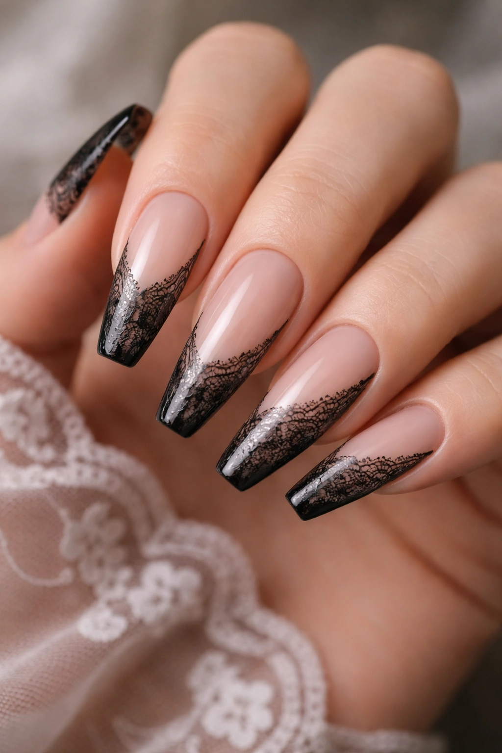 Sheer nude ballerina nails with delicate black lace veils