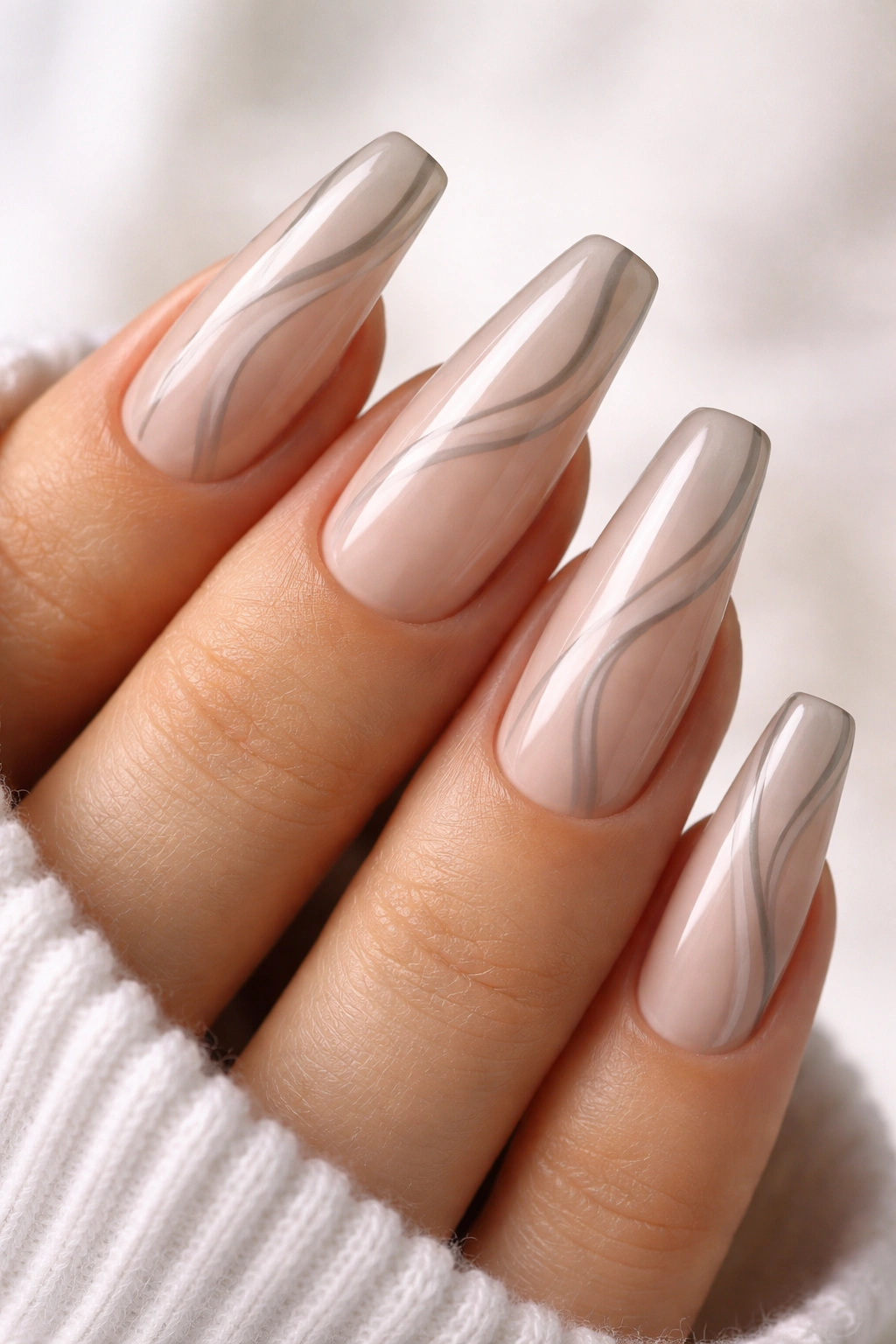 Sheer nude nails with soft grey swirl lines