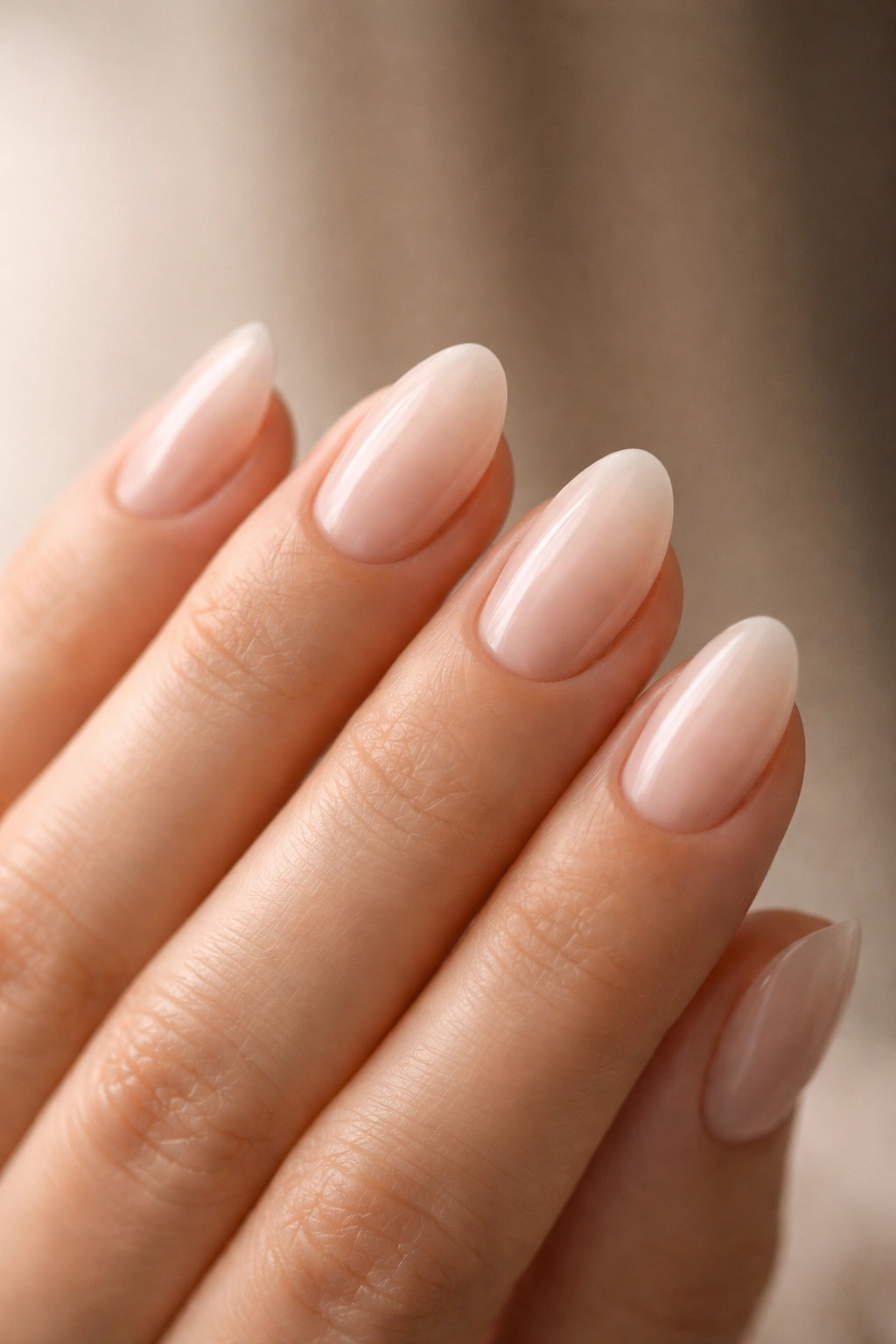 Hand showing different extra-short almond nail lengths to illustrate length choice