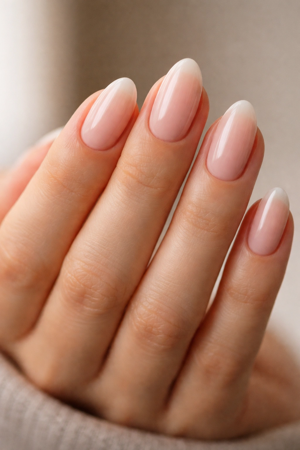 Close-up of short almond nails highlighting balanced almond shape and centered tips
