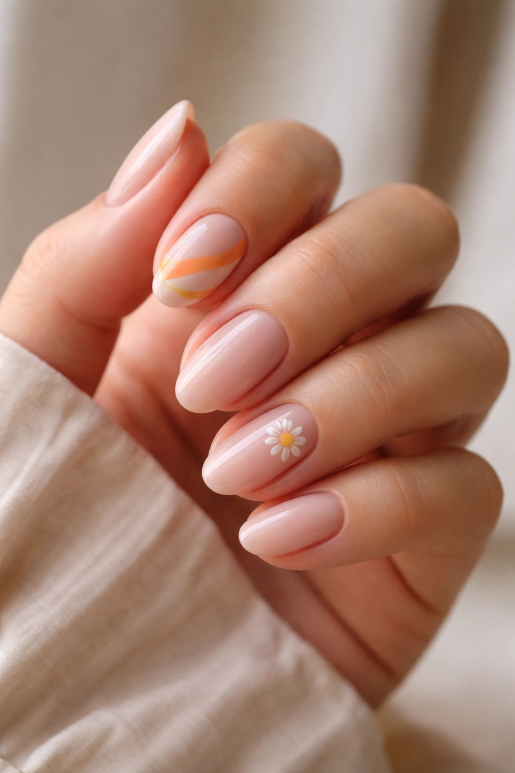 Close-up of balanced short retro almond nails with restrained accents