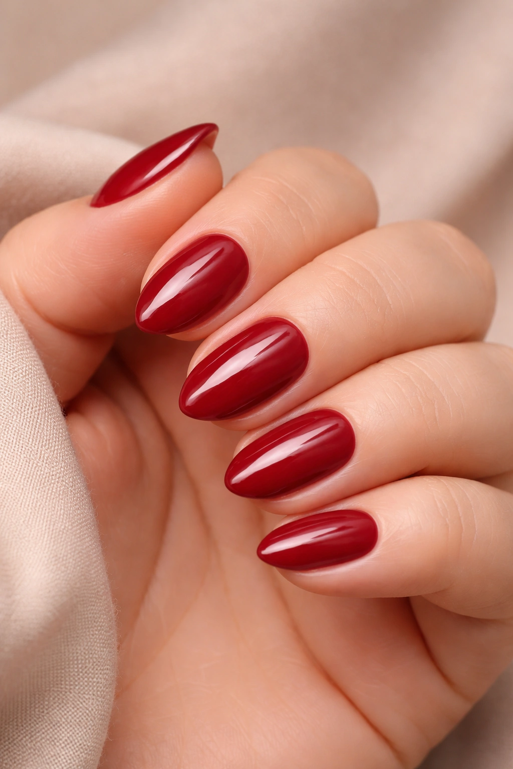 Close-up of short almond nails in rich color