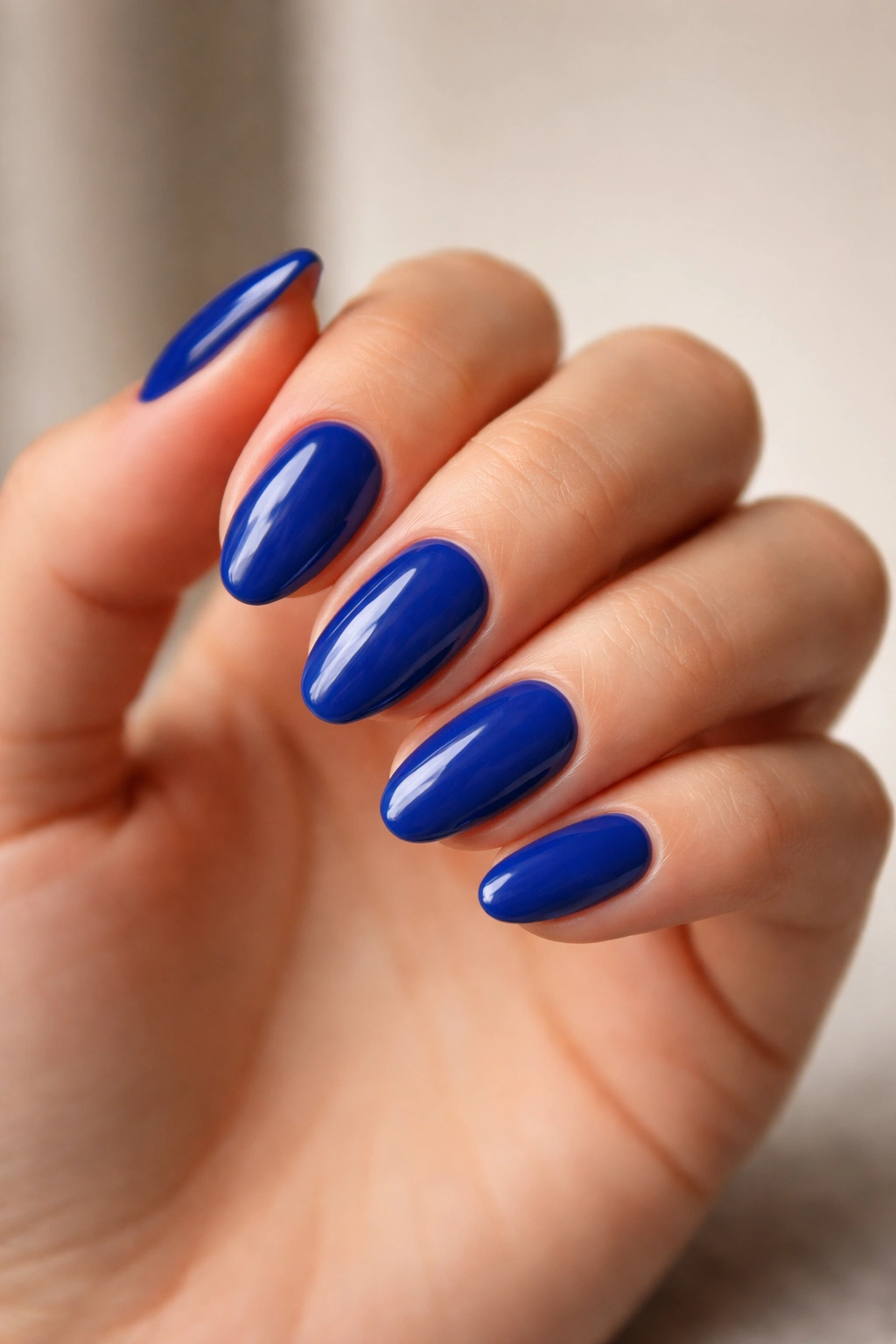 Close-up of hand with crisp short almond nails and slim tapered tips