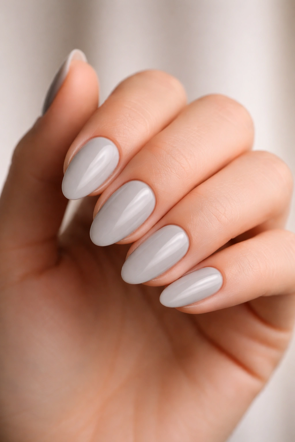 Close-up of short almond nails showing balanced length and tapered shape