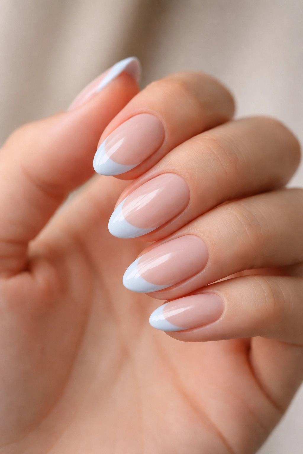 Close-up of short almond nails with soft taper and gentle rounded tips for French tips