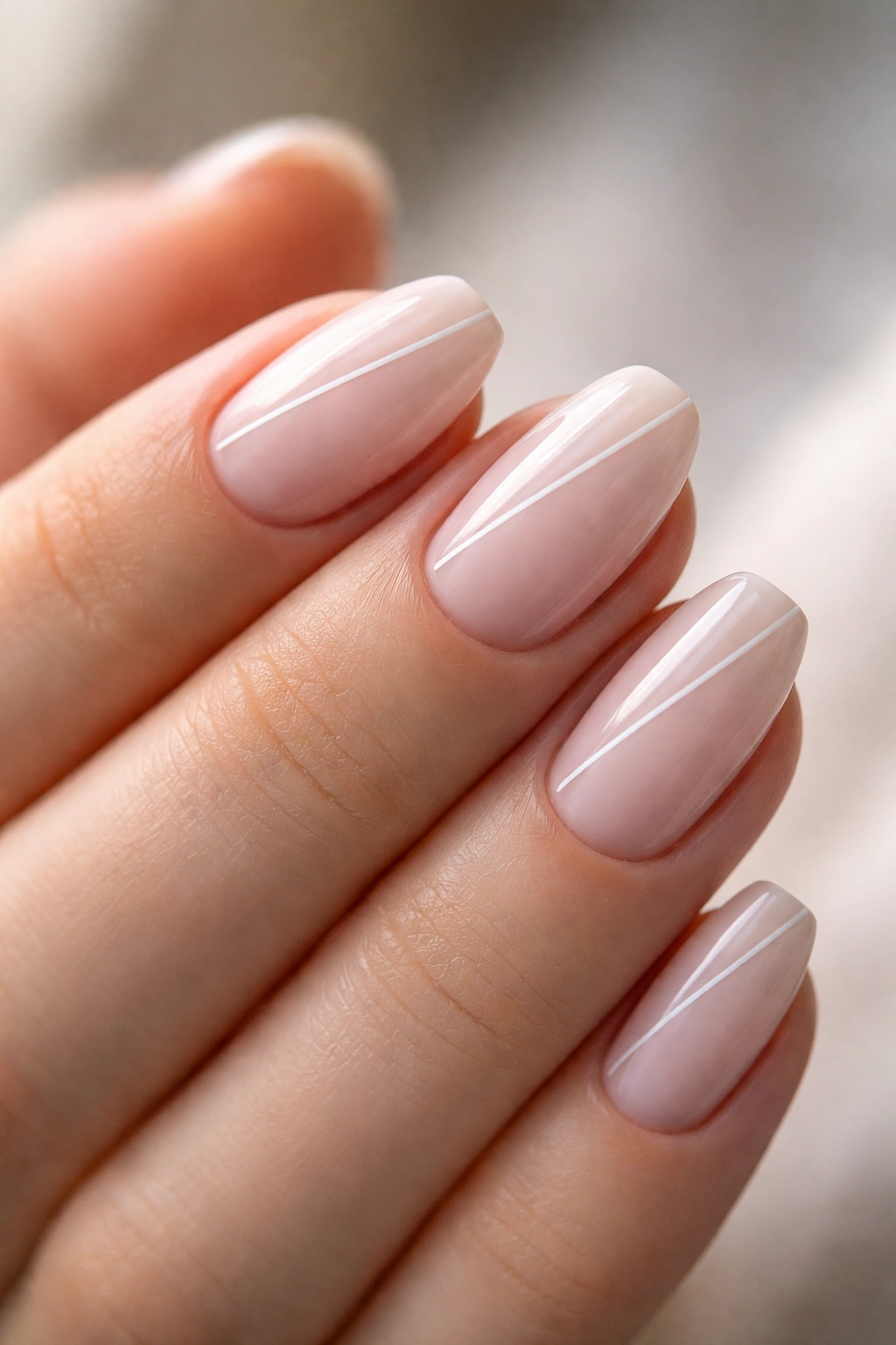 Close-up of ultra-short ballerina nails with thin line design and clean tapered tips
