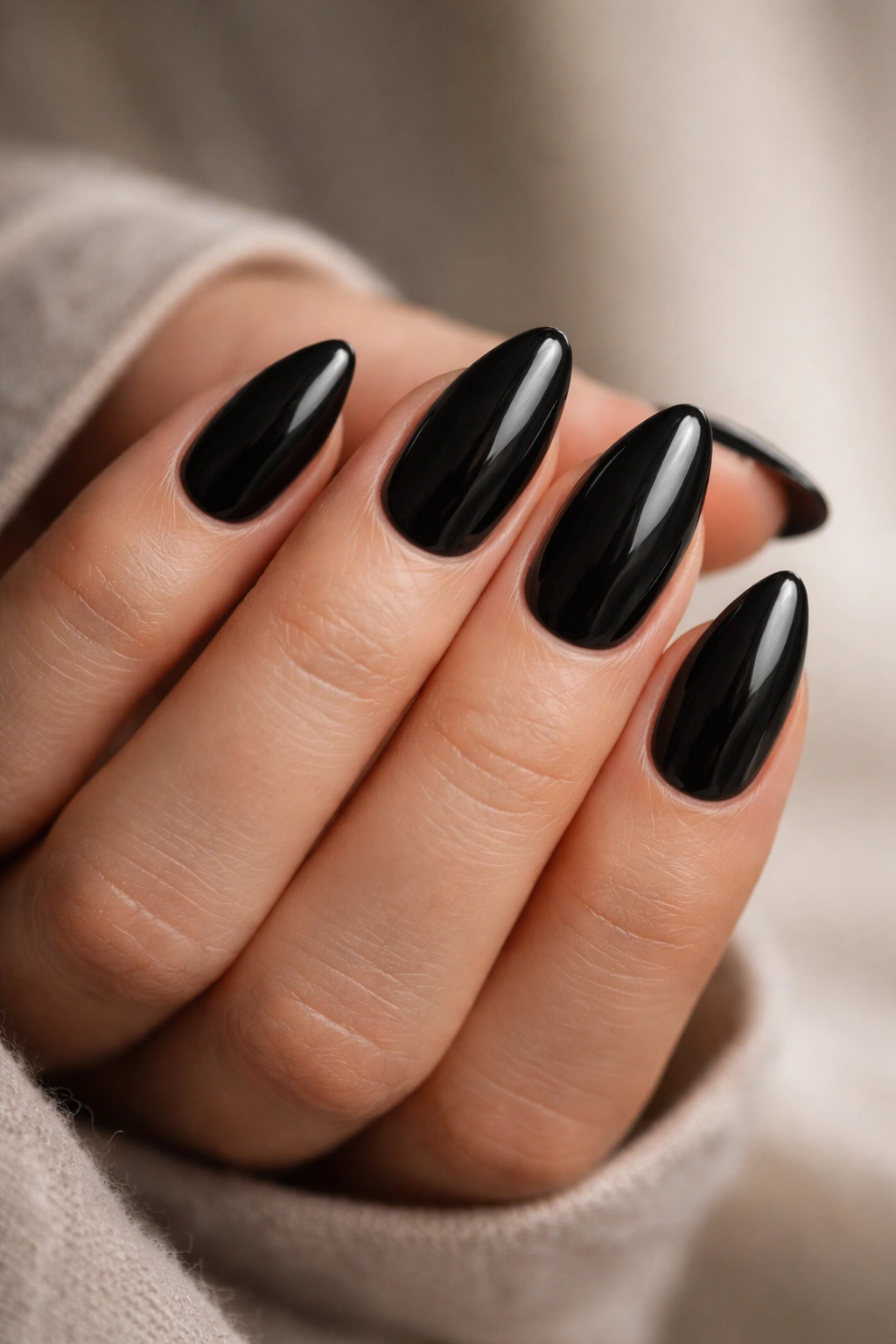 Hand with short almond nails neatly shaped and polished