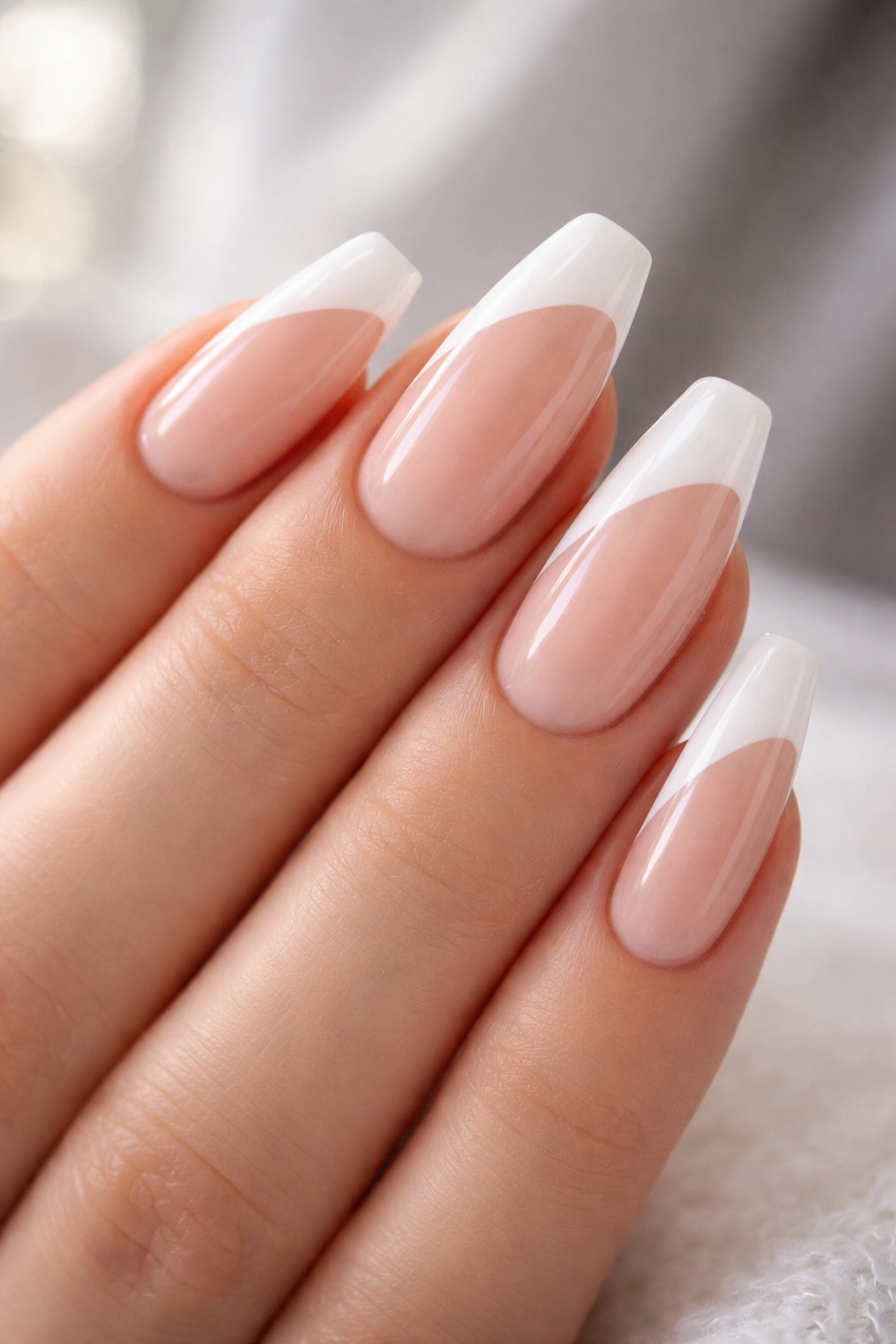 Close-up of side-swept diagonal white tips on ballerina nails