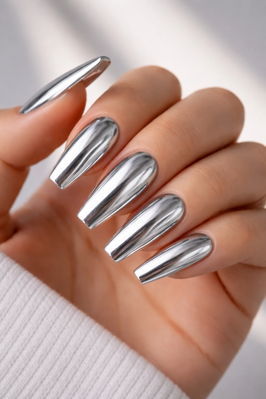 Silver chrome over gray-based ballerina nails close-up