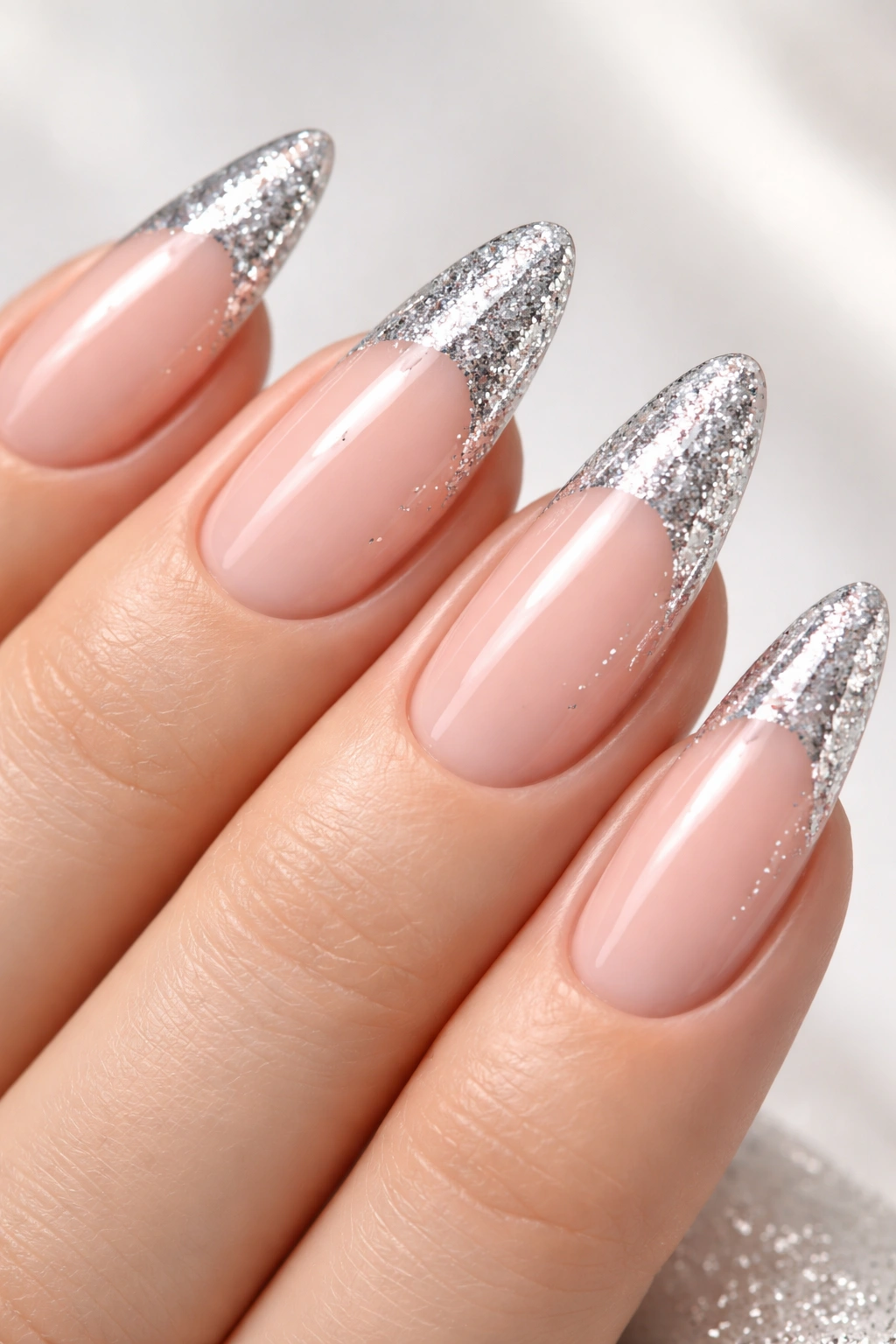 Silver sparkle French tips close-up on nails with glittery tips