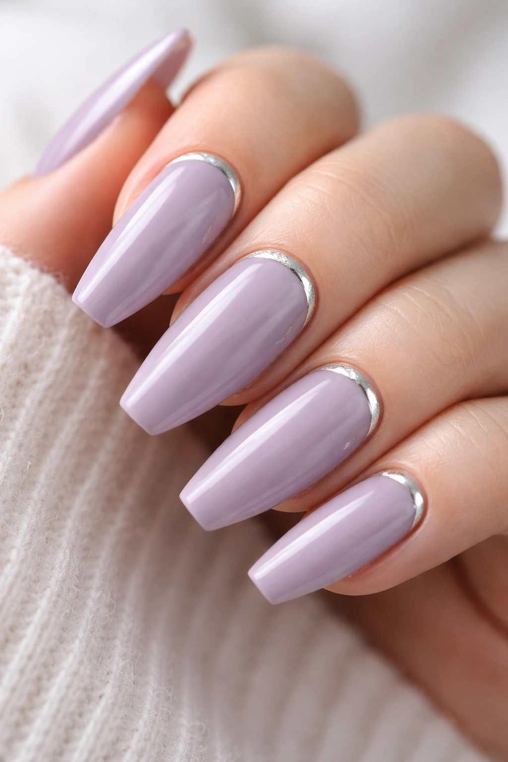 Close-up of nails with dusty lilac and silver cuticle half-moons