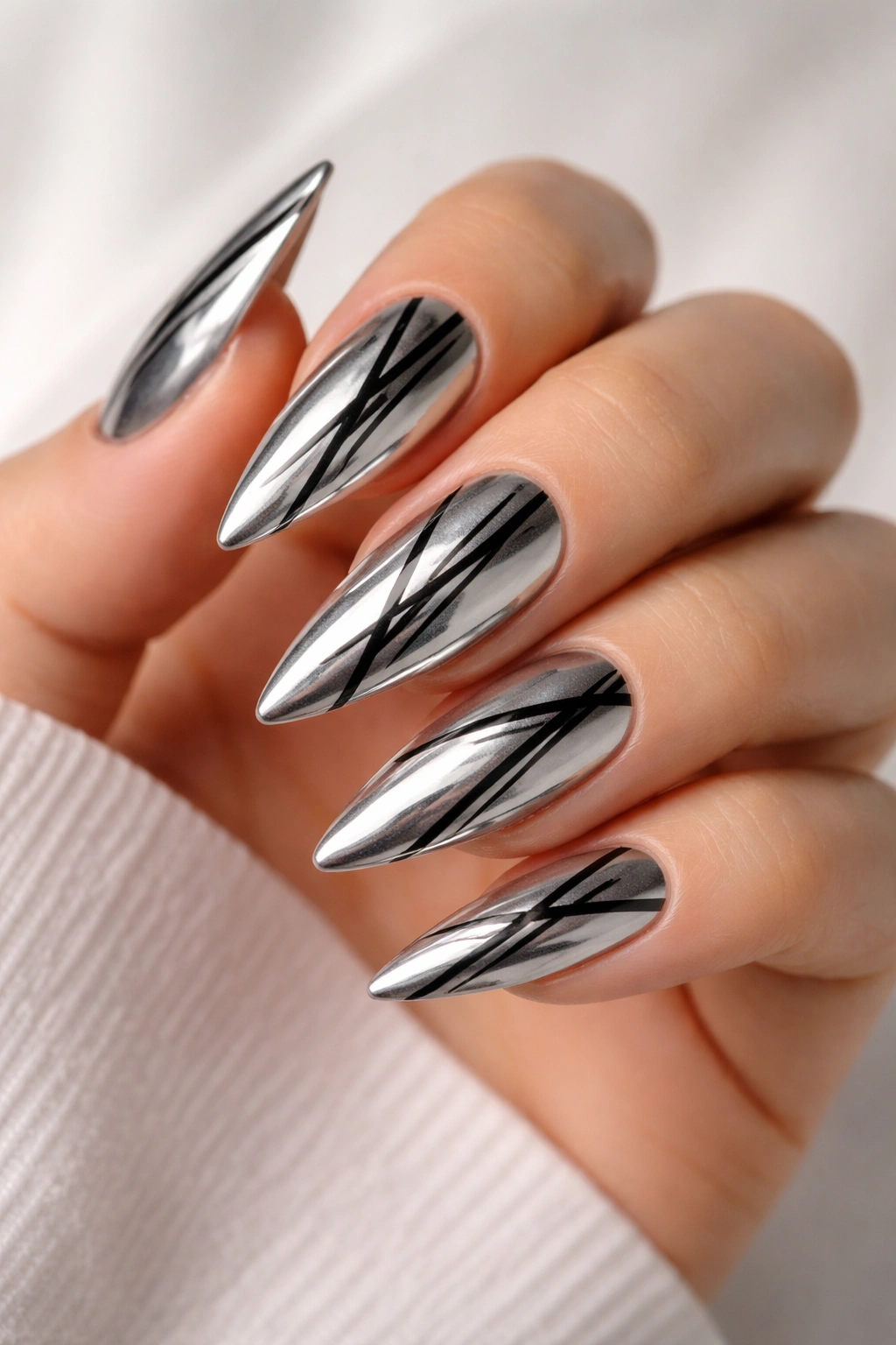 Silver metallic nails with black stripes on stiletto shape